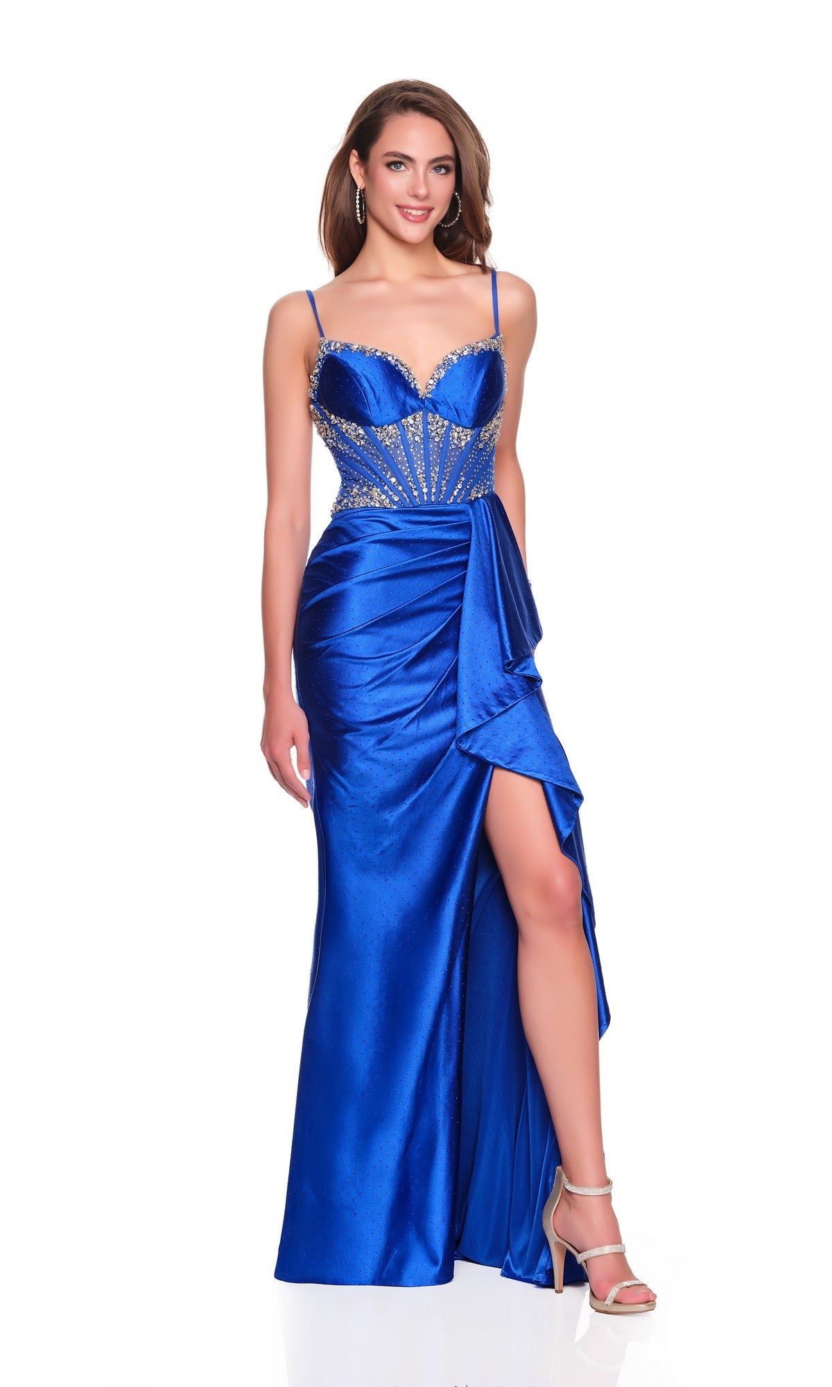 A woman models the Dave and Johnny 12754 long prom dress—satin blue with a fitted corset bodice, beading, thigh-high slit—and strappy heels, standing against a white background.